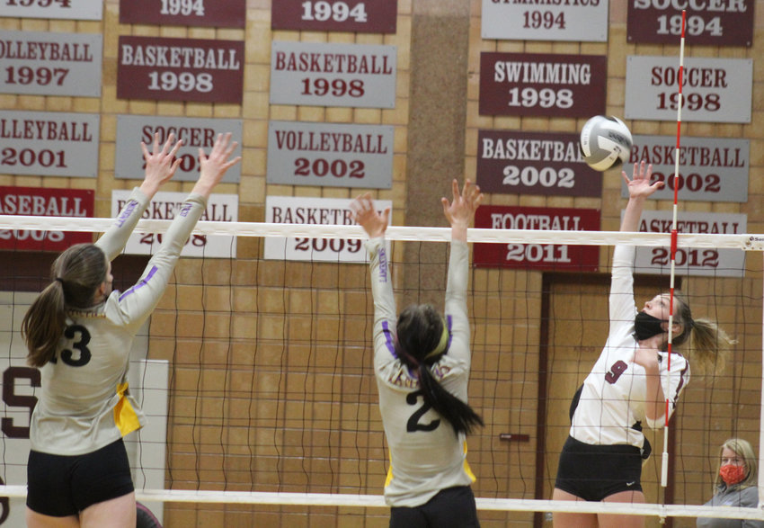 Horizon's Logan Kuehn gets set for the play at the net against the defense of Fort Collins' Emily Johnson (13) and Sophia Acott during a Front Range League game April 9 in Thornton.